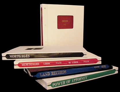 Compact books shown with a variety of colored backs